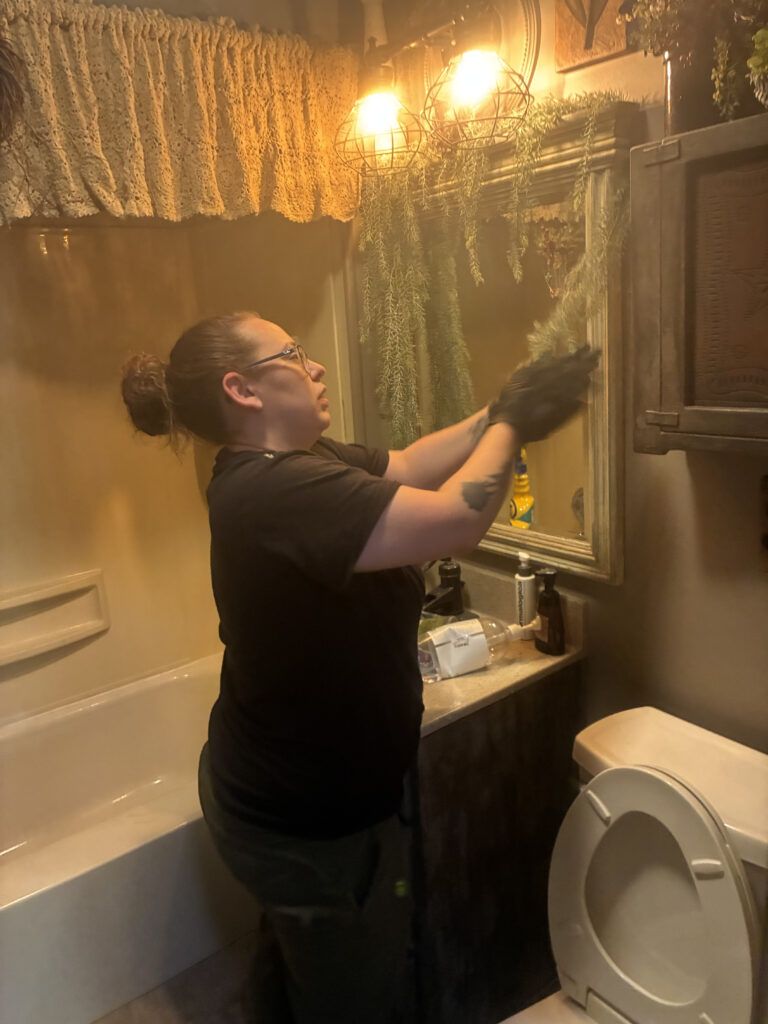 Bathroom cleaning mirror wiping — My Simple Cleaning professional house cleaning