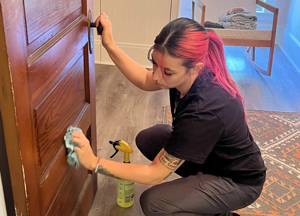 House cleaning in Westlake, OH — cleaner wiping door trim detail