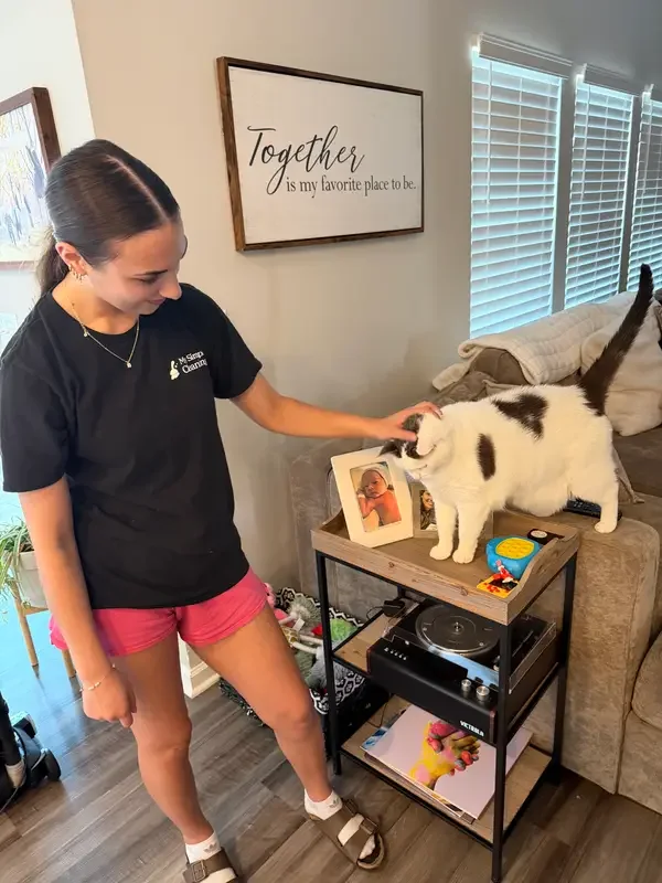 My Simple Cleaning team member with a family cat during an hourly cleaning visit